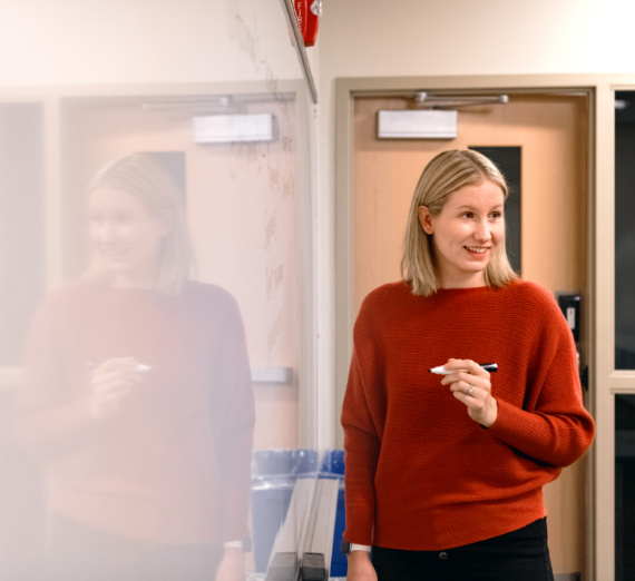 Reyes walks with umbrella through a snowy campus 